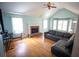 Bright living room features hardwood floors, a brick fireplace, and vaulted ceilings for an airy feel at 670 Maplelake Dr, Acworth, GA 30101