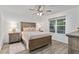 Comfortable bedroom with wood-look flooring, ceiling fan, and neutral decor at 7650 Rico Rd, Chattahoochee Hills, GA 30268