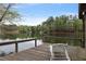 Lakeside view from a wooden deck with a comfortable lounge chair at 7650 Rico Rd, Chattahoochee Hills, GA 30268