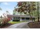 Charming home exterior with landscaped front yard and long driveway, showcasing curb appeal and privacy at 7650 Rico Rd, Chattahoochee Hills, GA 30268