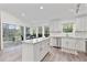 Bright kitchen features center island, stainless steel appliances, granite counters, and screened-in patio access at 7650 Rico Rd, Chattahoochee Hills, GA 30268