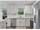 Bright kitchen with white cabinets, stainless steel appliances and subway tile backsplash at 7650 Rico Rd, Chattahoochee Hills, GA 30268