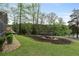 A picturesque lawn and landscaping lead to the serene lakefront view at 7650 Rico Rd, Chattahoochee Hills, GA 30268