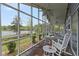 Screened patio boasts beautiful lake views with outdoor seating at 7650 Rico Rd, Chattahoochee Hills, GA 30268