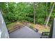 An elevated view from a large deck offers a picturesque view of the lush backyard at 1043 Middlebrooke Dr, Canton, GA 30115