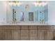Bathroom featuring a double vanity, elegant lighting, and a view of the glass-enclosed shower at 1043 Middlebrooke Dr, Canton, GA 30115