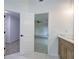 Bathroom featuring wood vanity cabinets with double doors leading to the bedroom and walk-in closet at 1043 Middlebrooke Dr, Canton, GA 30115
