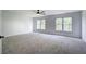 Spacious carpeted bedroom with neutral walls, ceiling fan and two windows offering great natural lighting at 1043 Middlebrooke Dr, Canton, GA 30115