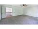 Neutral bedroom with soft gray carpet, ceiling fan, and an open doorway to a naturally lit space at 1043 Middlebrooke Dr, Canton, GA 30115