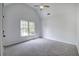 Bright bedroom with vaulted ceilings, plush gray carpet, and a large window providing natural light at 1043 Middlebrooke Dr, Canton, GA 30115
