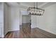 Dining room with dark wood floors and contemporary light fixture at 1043 Middlebrooke Dr, Canton, GA 30115