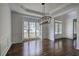 Dining room with dark wood floors, wainscoting, and a large window at 1043 Middlebrooke Dr, Canton, GA 30115