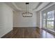 Formal dining room with dark wood floors, a modern chandelier and wainscoting at 1043 Middlebrooke Dr, Canton, GA 30115