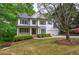 Lovely two-story home featuring a covered porch, black shutters, and a lush green lawn at 1043 Middlebrooke Dr, Canton, GA 30115