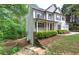 Two-story home with a covered porch and beautiful landscaping surrounding the property at 1043 Middlebrooke Dr, Canton, GA 30115