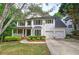 Traditional two-story home with a two-car garage, covered porch, and well-manicured lawn at 1043 Middlebrooke Dr, Canton, GA 30115