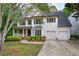 Stately two-story home with a covered porch, lush landscaping, and a convenient two-car garage at 1043 Middlebrooke Dr, Canton, GA 30115