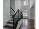 Grand foyer with a staircase and a front door with glass panels at 1043 Middlebrooke Dr, Canton, GA 30115