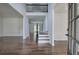 Open concept foyer with dark hardwood floors, wainscotting, and view into living spaces at 1043 Middlebrooke Dr, Canton, GA 30115