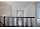 Foyer looking down to front door with dark wood floors and a wrought iron railing at 1043 Middlebrooke Dr, Canton, GA 30115