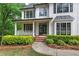Charming home featuring a covered front porch, black shutters, and a brick pathway at 1043 Middlebrooke Dr, Canton, GA 30115