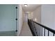 Hallway with soft gray carpet and black wrought iron railing at 1043 Middlebrooke Dr, Canton, GA 30115