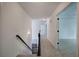 Carpeted hallway with black railing, leading to open doors, creating a sense of spaciousness at 1043 Middlebrooke Dr, Canton, GA 30115