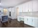Modern kitchen with white cabinets, center island, and hardwood flooring at 1043 Middlebrooke Dr, Canton, GA 30115