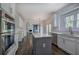Open kitchen with stainless steel appliances, hardwood floors, and gray island at 1043 Middlebrooke Dr, Canton, GA 30115