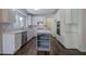 Modern kitchen features white cabinets, stainless steel appliances, an island and stylish backsplash at 1043 Middlebrooke Dr, Canton, GA 30115