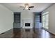 Cozy living room featuring a fireplace, built-in bookshelves, and a ceiling fan at 1043 Middlebrooke Dr, Canton, GA 30115