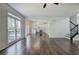 Open floor plan living room with windows, deck access, and a partial view of the kitchen at 1043 Middlebrooke Dr, Canton, GA 30115