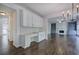 Open-concept living space with hardwood floors, custom cabinets, and a cozy fireplace with built-in shelving at 1043 Middlebrooke Dr, Canton, GA 30115