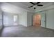 Spacious main bedroom with a tray ceiling, neutral carpet, and doorways to the ensuite bathroom and walk-in closet at 1043 Middlebrooke Dr, Canton, GA 30115