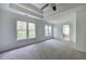 Bright main bedroom with tray ceilings and large windows overlooking the lush greenery at 1043 Middlebrooke Dr, Canton, GA 30115