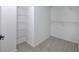 A well-organized walk-in closet with metal shelving for optimal storage and carpeted floor at 1043 Middlebrooke Dr, Canton, GA 30115
