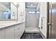 Modern bathroom with double sink vanity, large mirror, and glass-enclosed shower at 151 Flat Shoals Ave # 13, Atlanta, GA 30316