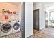 Laundry room with side-by-side washer and dryer, patterned floor, and storage shelf at 151 Flat Shoals Ave # 13, Atlanta, GA 30316