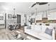 An open-concept living space featuring hardwood floors, stainless steel appliances and a cozy sofa with natural light at 151 Flat Shoals Ave # 13, Atlanta, GA 30316