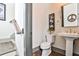 Powder room featuring a pedestal sink, decorative mirror, and wood-look flooring at 151 Flat Shoals Ave # 13, Atlanta, GA 30316