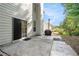 Backyard concrete patio with sliding glass door to interior at 1916 Oakwood Grove Dr, Snellville, GA 30078