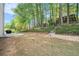 View of the backyard featuring a patio, mature trees and lawn at 1916 Oakwood Grove Dr, Snellville, GA 30078