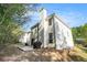 Exterior view of the back of the home and its spacious backyard and patio at 1916 Oakwood Grove Dr, Snellville, GA 30078