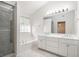 Bright bathroom with a soaking tub, shower, and double sink vanity with marble floors at 1916 Oakwood Grove Dr, Snellville, GA 30078