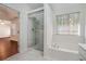 Bright bathroom with a soaking tub, shower, and marble tile at 1916 Oakwood Grove Dr, Snellville, GA 30078