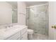 Bathroom featuring a marble vanity, toilet, and large shower with marble tile at 1916 Oakwood Grove Dr, Snellville, GA 30078