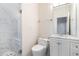 Bathroom features glass shower stall and vanity with marble countertop and wood-look cabinets at 1916 Oakwood Grove Dr, Snellville, GA 30078