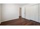 Spacious bedroom with laminate wood flooring and white bi-fold closet doors at 1916 Oakwood Grove Dr, Snellville, GA 30078