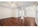 Large bedroom with hardwood floors, tray ceilings, ceiling fans, and view of ensuite bathroom at 1916 Oakwood Grove Dr, Snellville, GA 30078