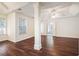 Large main bedroom with tray ceiling, hardwood floors, and access to ensuite bathroom at 1916 Oakwood Grove Dr, Snellville, GA 30078